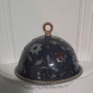 ceramic cheese or butter dome with a decorative, hand-painted pattern.